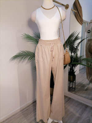 Pantalón de lino con bolsos atrás beige